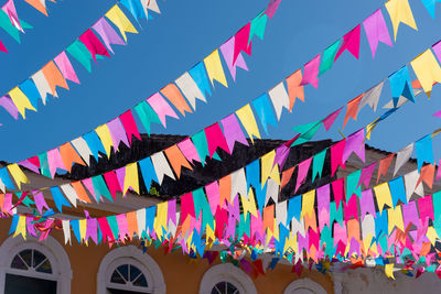 Low angle view of multi colored flags