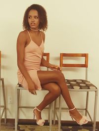 Portrait of young woman sitting on chair