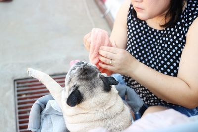 Midsection of woman with dog outdoors