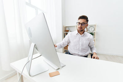Portrait of businessman using laptop at home