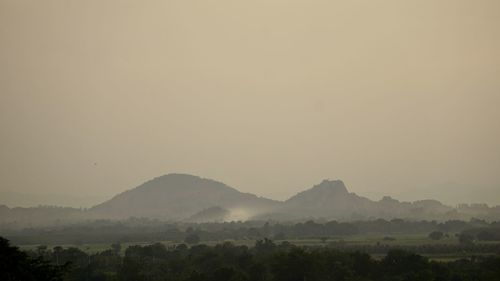 Scenic view of mountains against sky during foggy weather