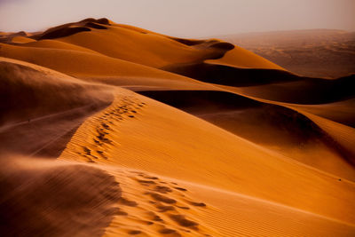 Close-up of sand dune in desert against sky