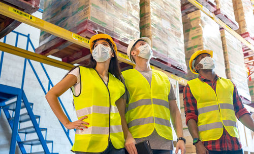 Colleagues wearing protective workwear while standing outdoors