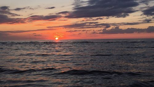 Scenic view of sea against sky at sunset