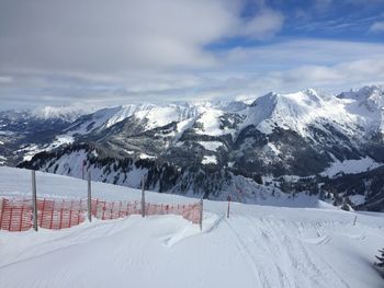 Scenic view of snow covered mountains against sky