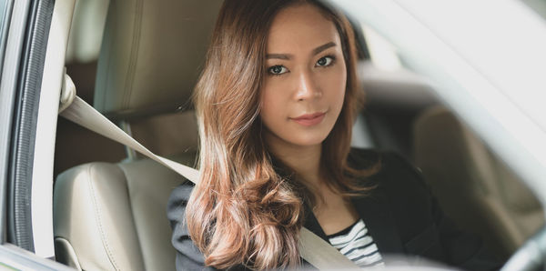 Portrait of woman sitting in car