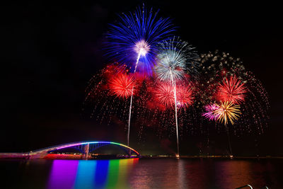 Low angle view of firework display at night