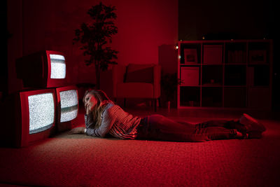 Woman sitting on sofa at home