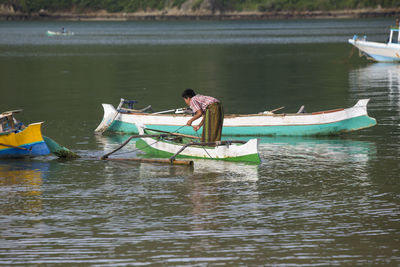 Fisherman on boat in lake