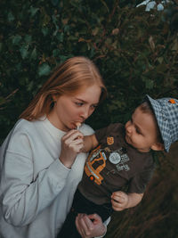 Mother and girl holding camera