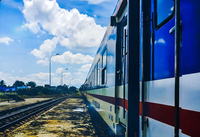 Train on railroad tracks against sky