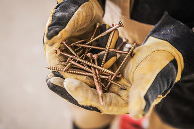 Cropped hands holding nails