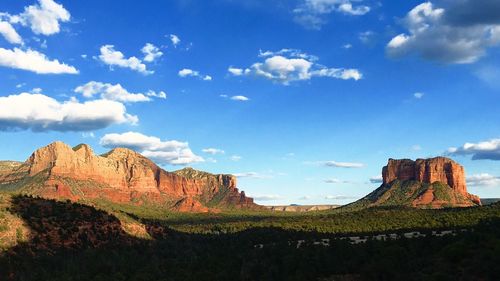 Scenic view of mountains against cloudy sky