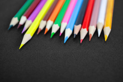 Close-up of multi colored pencils on table