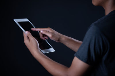 Midsection of woman using mobile phone