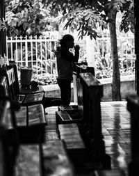 Side view of woman praying at church