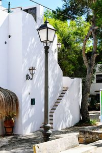 White street light against trees and building