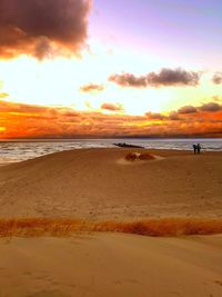 Scenic view of beach against sky during sunset