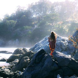 Full length of woman standing on rock formation