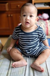 Portrait of cute boy sitting at home