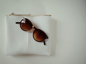 Directly above shot of sunglasses on purse