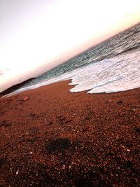 Scenic view of beach against sky during sunset