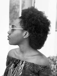 Young woman with curly hair looking away