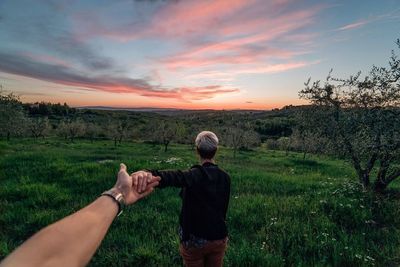 Scenic view of grassy field against sky