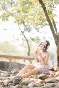 Woman sitting on rock