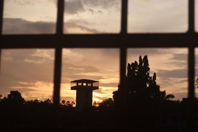 Silhouette building against sky during sunset