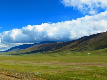 Scenic view of landscape against cloudy sky