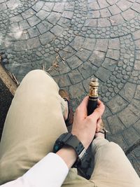 Low section of man smoking cigarette