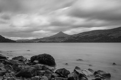 Scenic view of sea and mountains against sky