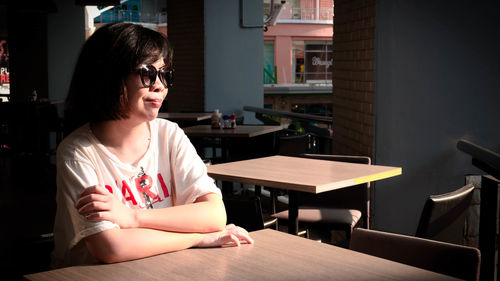 Woman sitting on table