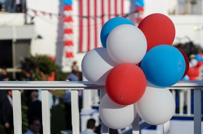 Close-up of balloons decoration on railing during independence day