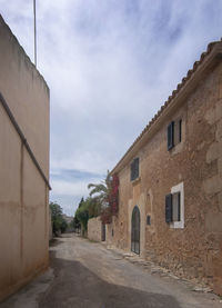 Street amidst buildings against sky