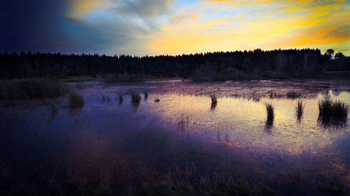 Scenic view of calm lake at sunset