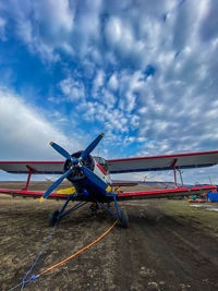 View of airplane on filed against sky