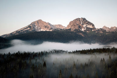 Scenic view of snowcapped mountains against clear sky