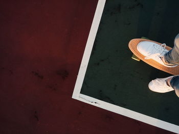 Low section of person standing on tiled floor