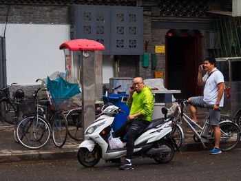 People riding bicycles on street in city