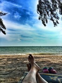 Low section of person relaxing on beach