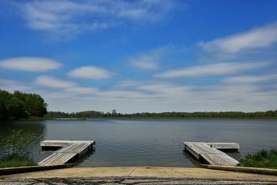 Pier over lake against sky