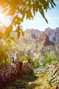 Woman sitting on mountain