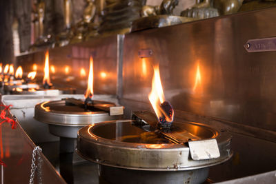 Lit tea light candles in building