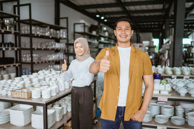 Portrait of young woman standing in store