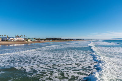 Scenic view of sea against clear blue sky