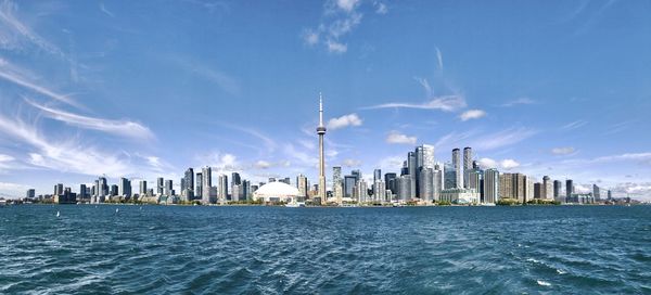 Panoramic view of sea and buildings against sky