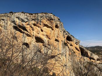 Low angle view of rock formations against sky