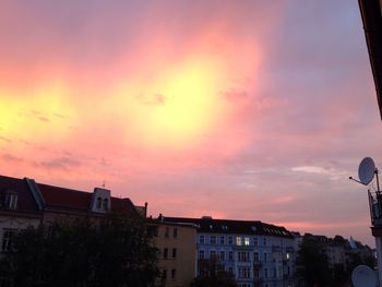 Low angle view of buildings against sky at sunset